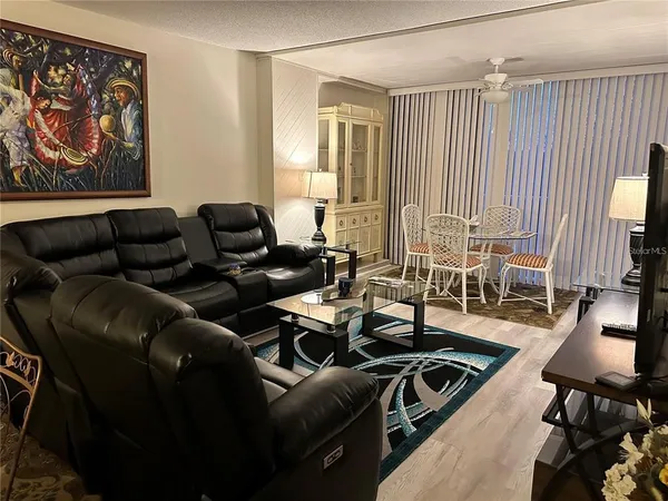 a living room with furniture a rug and a flat screen tv