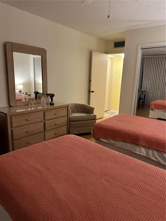 a bedroom with two beds and a dresser