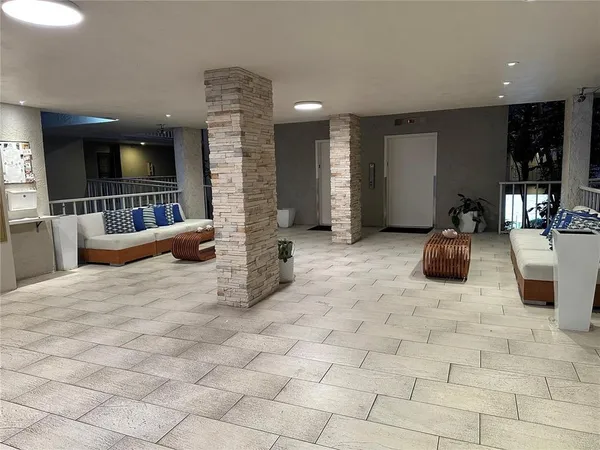 a lobby with furniture and window