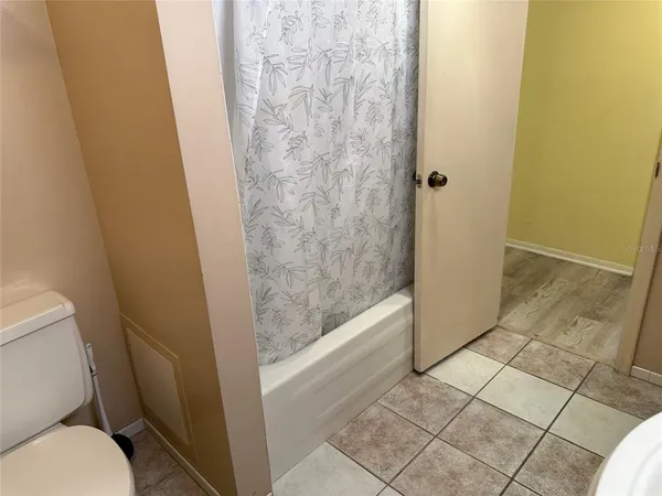 a bathroom with a granite countertop toilet and a shower