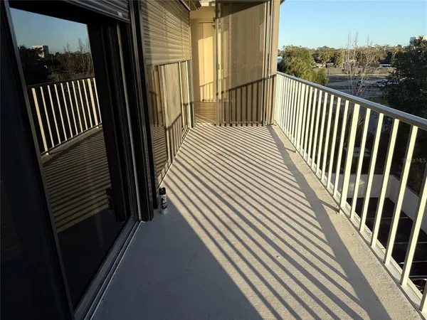 a view of a balcony with wooden floor