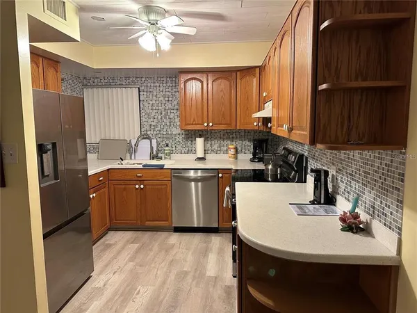 a kitchen with a sink cabinets and stainless steel appliances