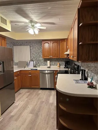 a kitchen with stainless steel appliances granite countertop a sink a stove and a refrigerator
