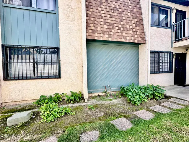 a view of a house with a yard and sitting area