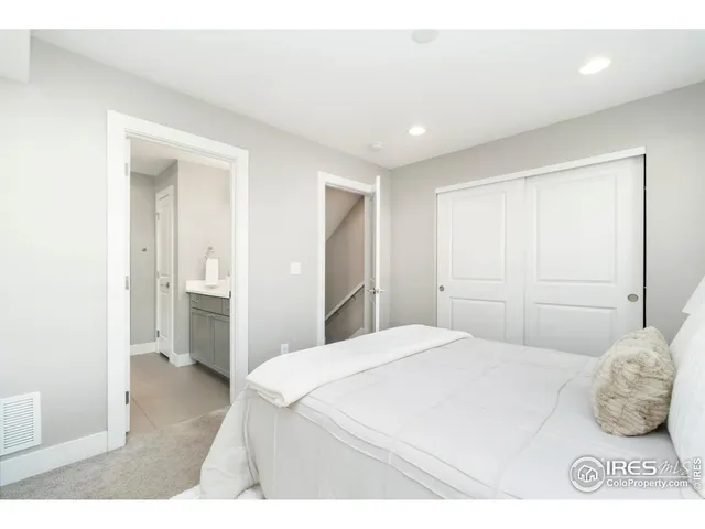 a bedroom with a bed and cabinets