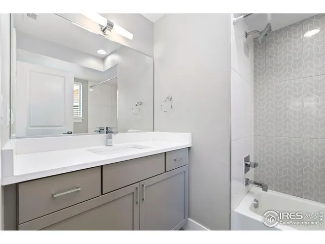 a bathroom with a sink a mirror and a shower