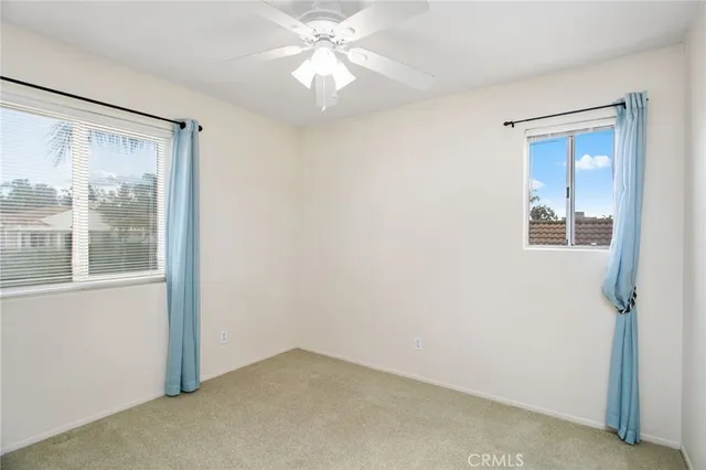 a bathroom with a toilet a sink a mirror and vanity