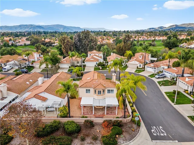 an aerial view of a residential houses with yard