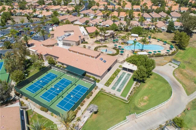 a view of a porch with furniture and floor to ceiling window