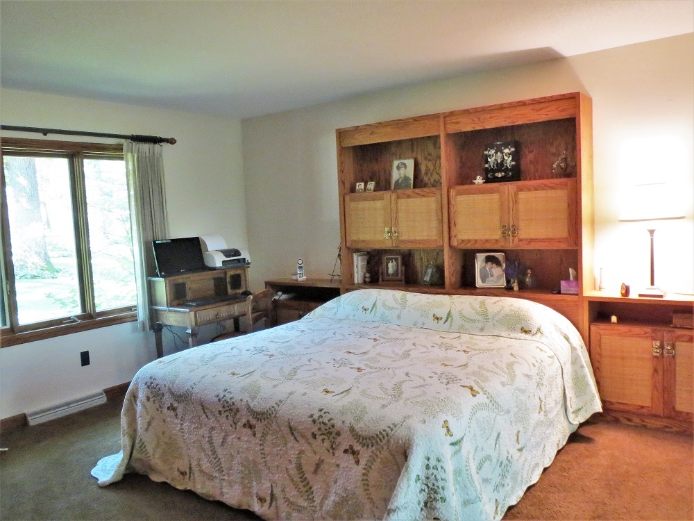 878 Riverside Drive Dixon, IL 61021 - Photo 18 of 45 a bed sitting in a bedroom next to a window