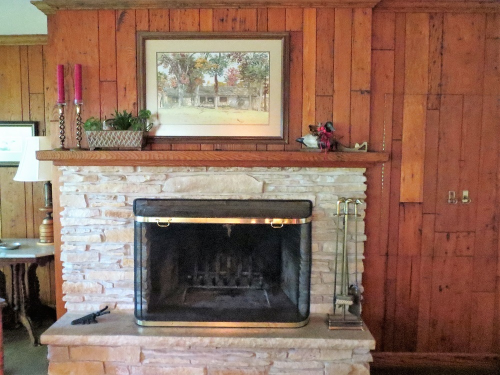 878 Riverside Drive Dixon, IL 61021 - Photo 6 of 45 a fireplace with a clock on top of it