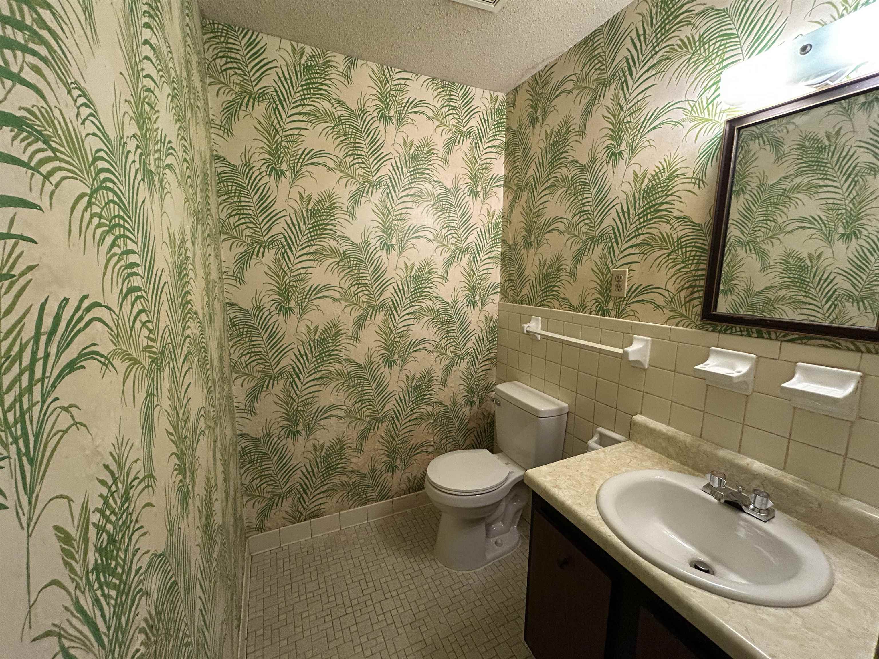 2800 Clarke Road, Unit 2 Memphis, TN 38115 - Photo 11 of 18 Bathroom featuring palm frond wallpaper, a white vanity with an integrated sink, mosaic tile flooring, and white ceramic wall tiles