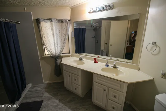 a bathroom with a double vanity sink and mirror
