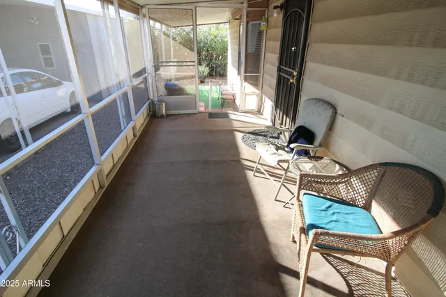 a view of a chairs and table in backyard