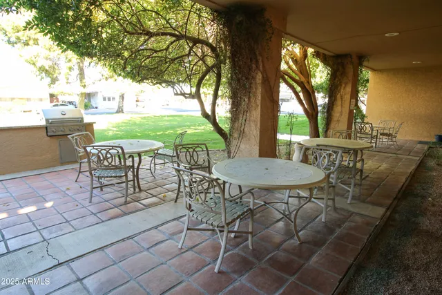a front view of a house with a garden and trees