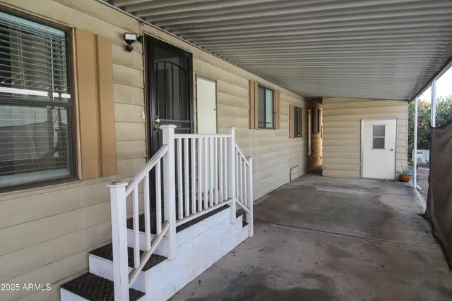 a view of a porch with wooden floor and stairs