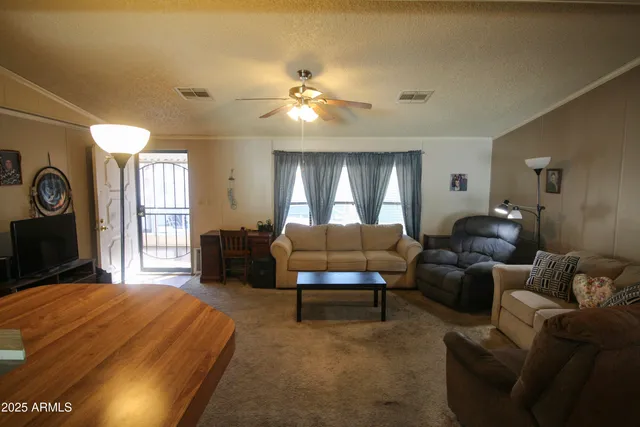 a spacious bedroom with a bed window and couch