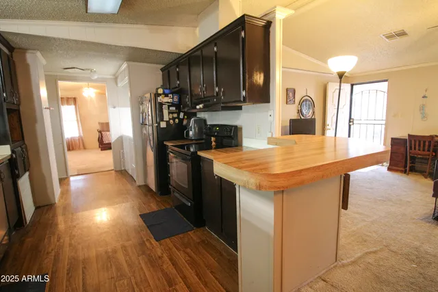 a kitchen with granite countertop a stove and refrigerator