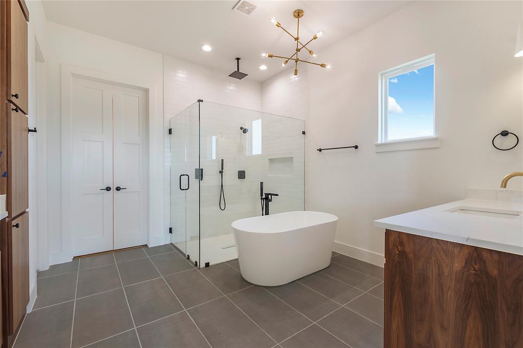 430 Whispering Way Red Oak, TX 75154 - Photo 38 of 40 Freestanding soaking tub with a walk-in glass shower, white subway tile surround, and matte black fixtures