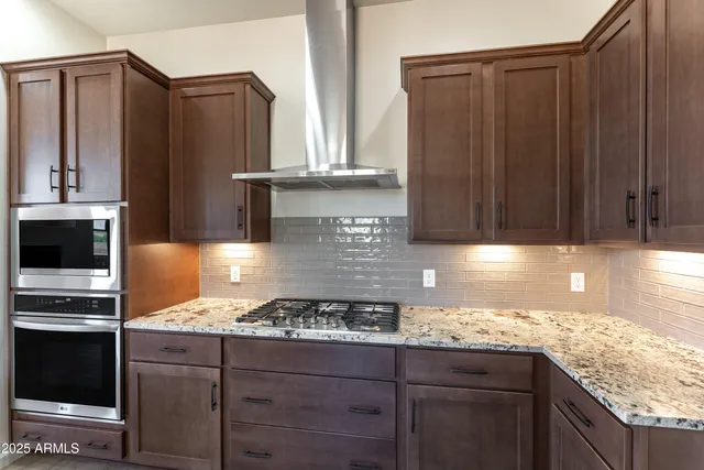 a kitchen with granite countertop cabinets and steel stainless steel appliances