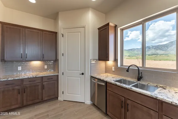 a kitchen with a sink and wooden cabinets