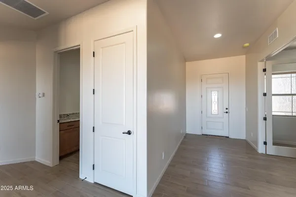 a view of a hallway with wooden floor