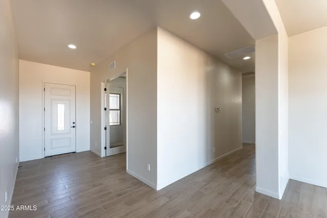a view of a hallway with wooden floor