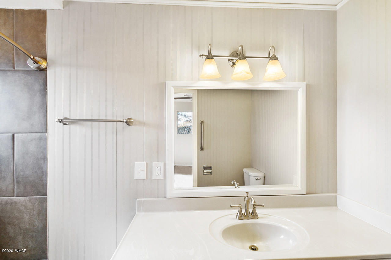 205 North 4th W Street Snowflake, AZ 85937 - Photo 13 of 24 a bathroom with a sink and a mirror