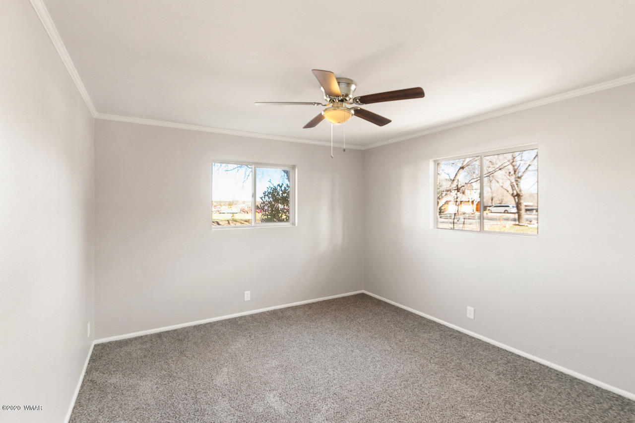 205 North 4th W Street Snowflake, AZ 85937 - Photo 16 of 24 an empty room with a window and a fan