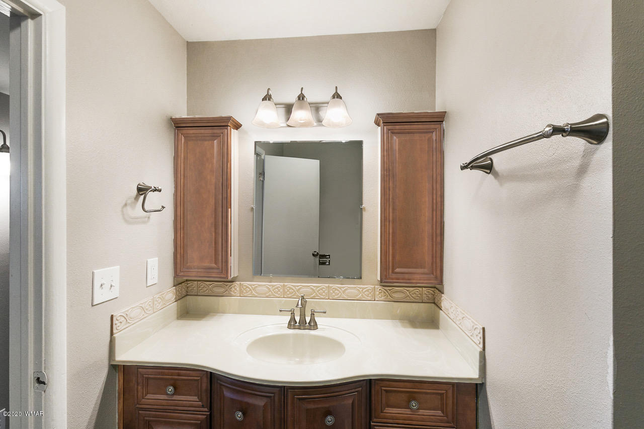 205 North 4th W Street Snowflake, AZ 85937 - Photo 17 of 24 a bathroom with a sink and a mirror