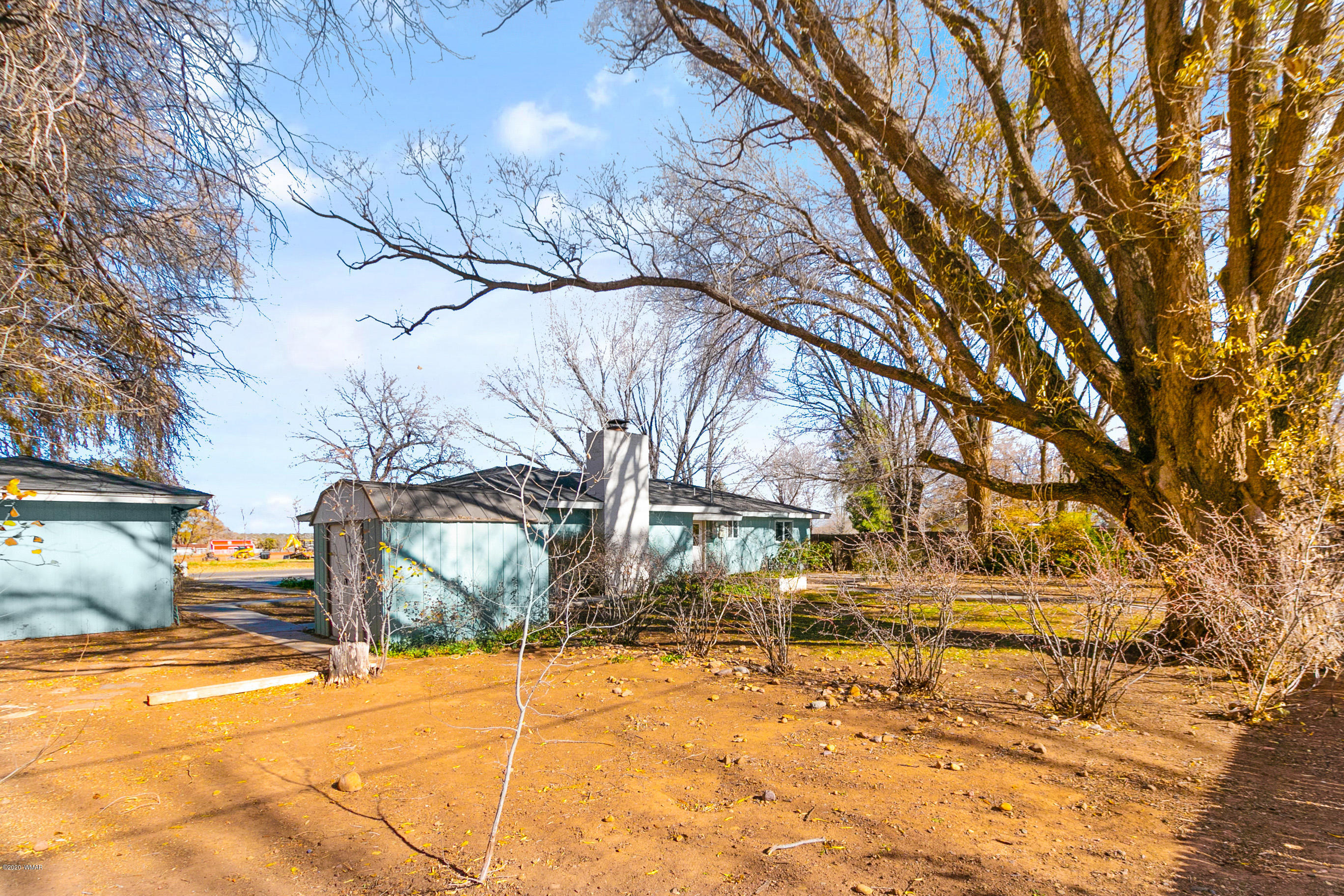 205 North 4th W Street Snowflake, AZ 85937 - Photo 20 of 24 a backyard of a house with large trees