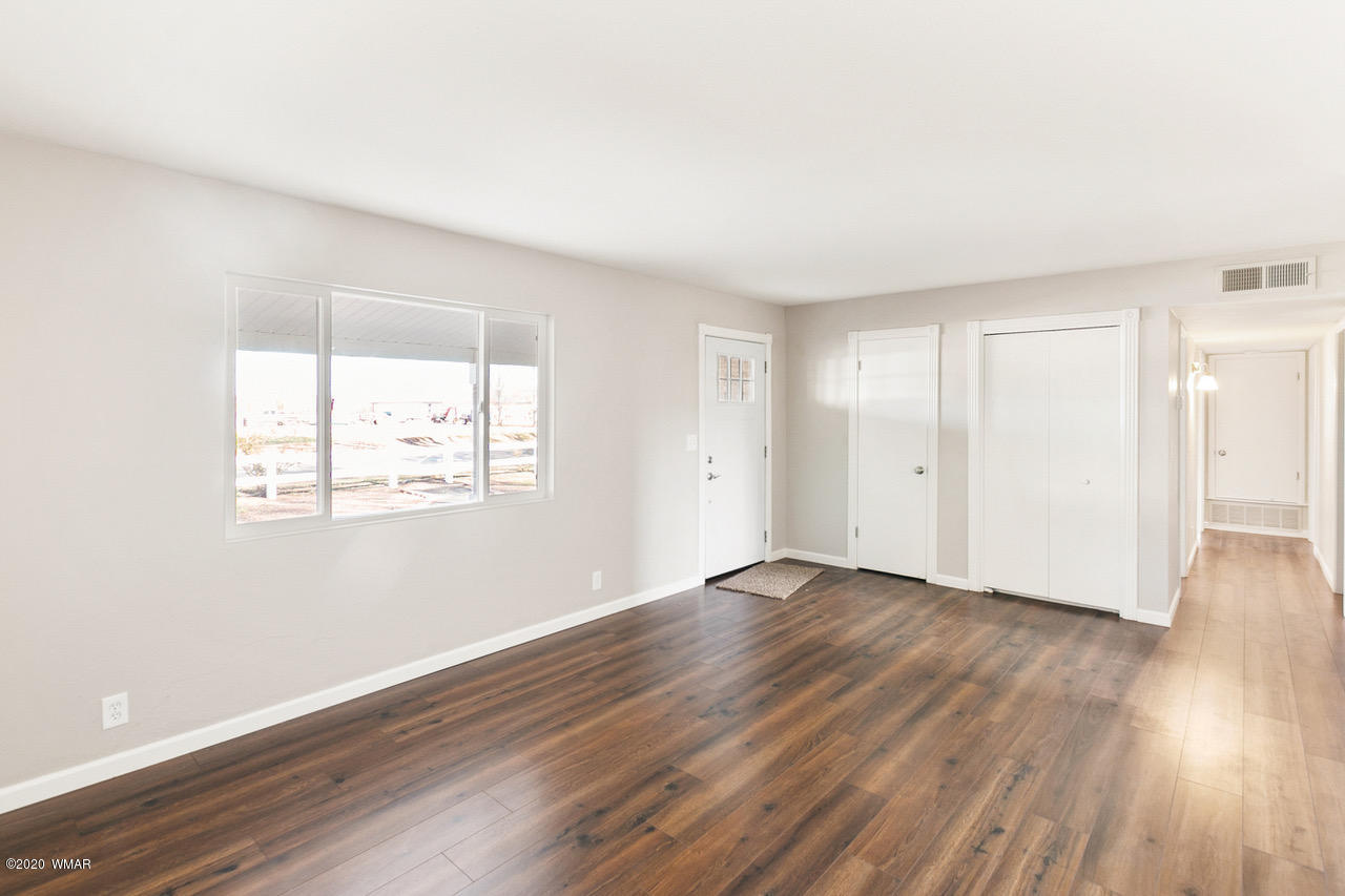 205 North 4th W Street Snowflake, AZ 85937 - Photo 2 of 24 an empty room with wooden floor and windows