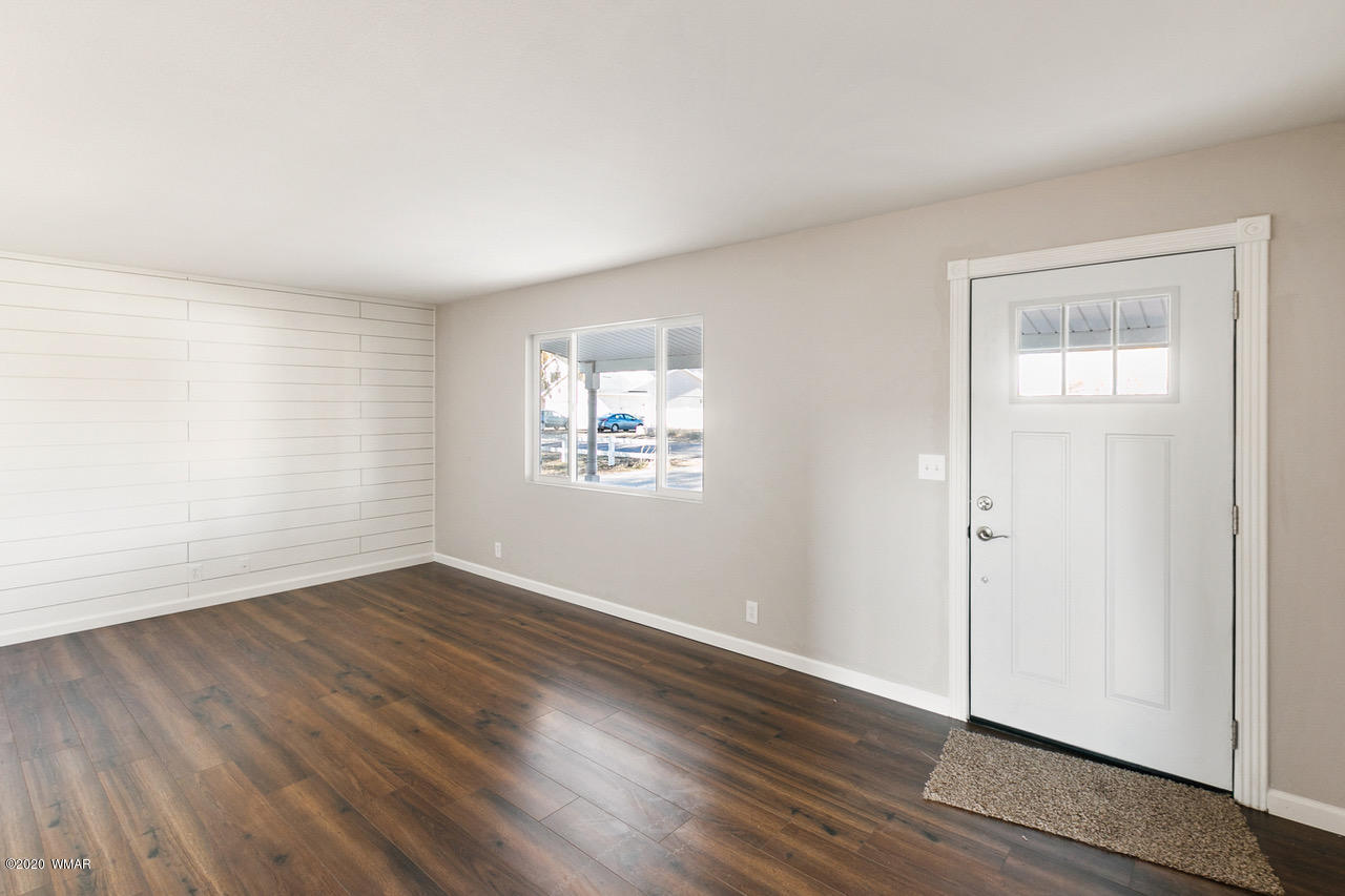 205 North 4th W Street Snowflake, AZ 85937 - Photo 3 of 24 an empty room with wooden floor and windows
