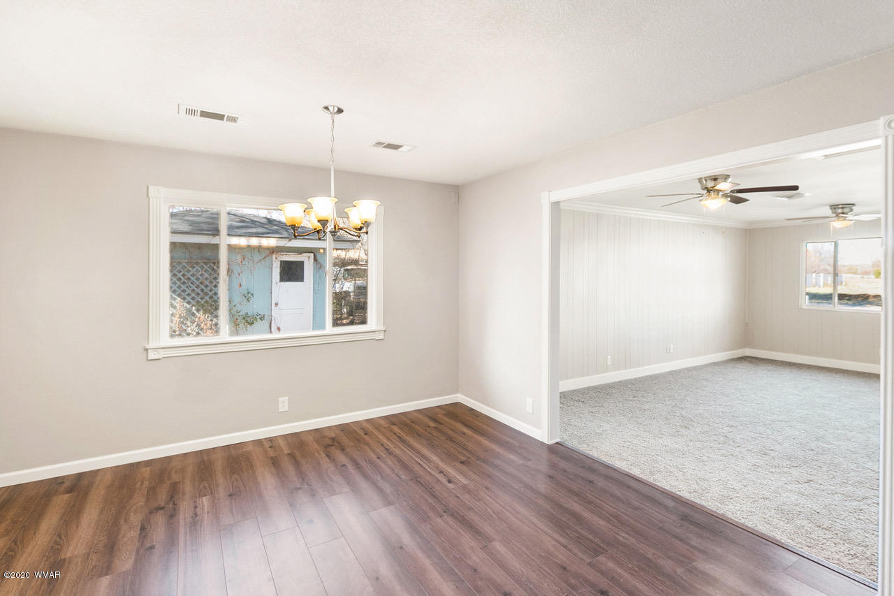 205 North 4th W Street Snowflake, AZ 85937 - Photo 6 of 24 a view of an empty room with wooden floor and a window