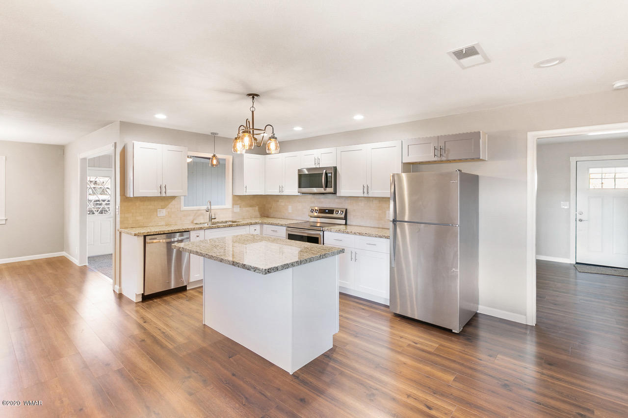 205 North 4th W Street Snowflake, AZ 85937 - Photo 7 of 24 a kitchen with a refrigerator a sink and a stove top oven
