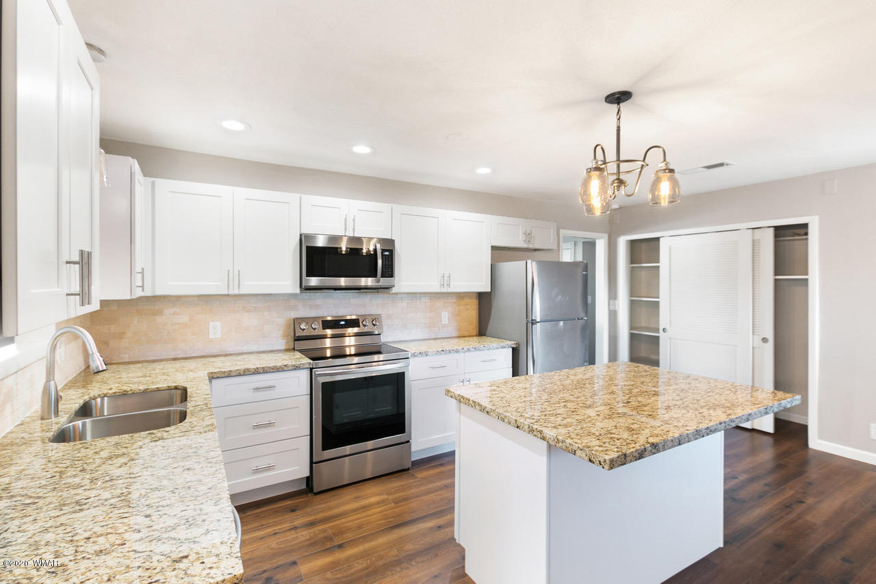 205 North 4th W Street Snowflake, AZ 85937 - Photo 8 of 24 a kitchen with stainless steel appliances granite countertop a sink stove and refrigerator