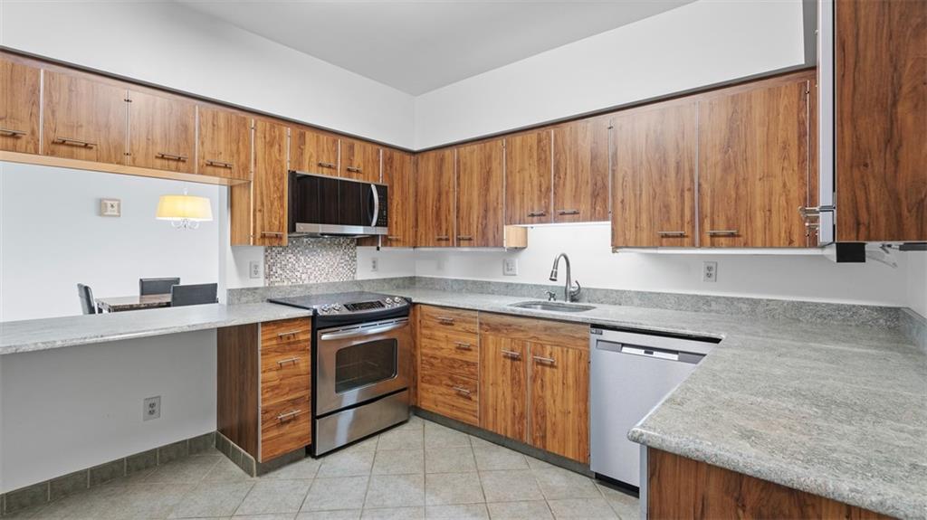 307 South Dithridge Street, Unit 810 Pittsburgh, PA 15213 - Photo 11 of 26 a kitchen with a sink stove top oven and cabinets
