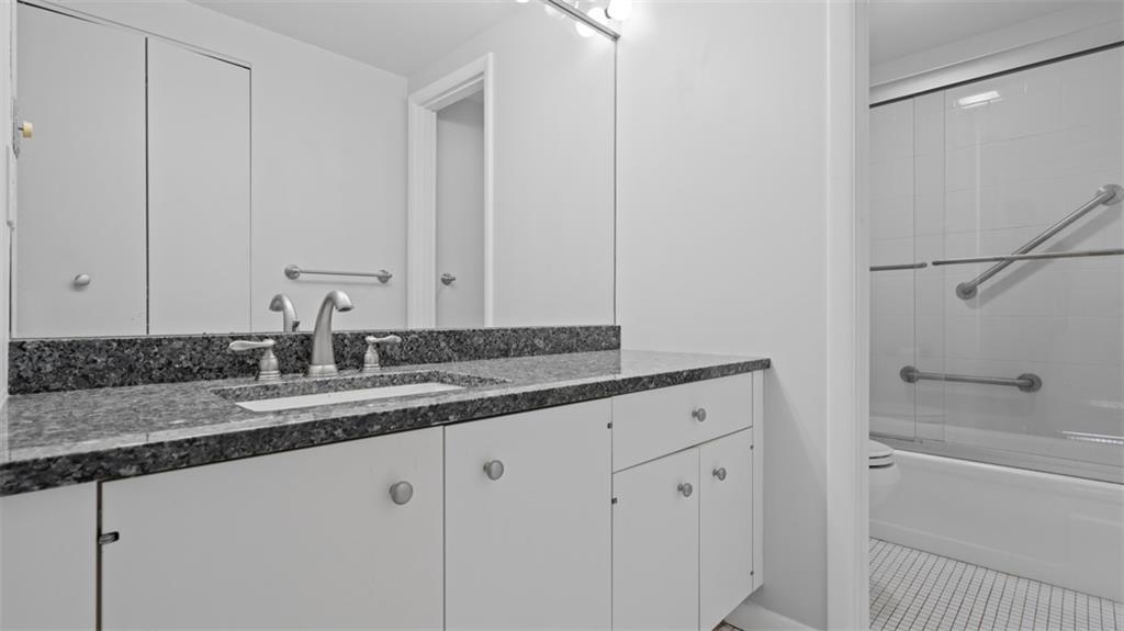 307 South Dithridge Street, Unit 810 Pittsburgh, PA 15213 - Photo 21 of 26 a bathroom with a granite countertop sink and a mirror