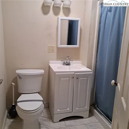 an empty room that has a wooden cupboard
