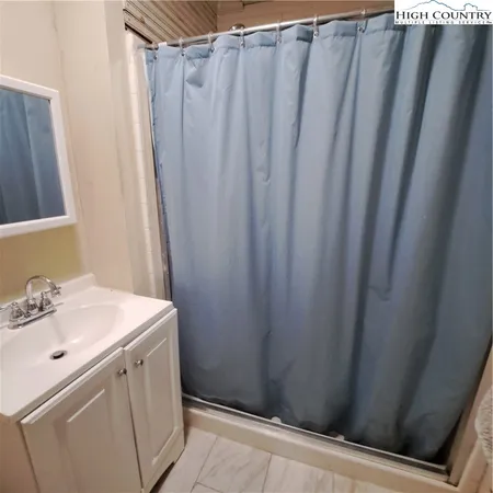 a room with a sink and a mirror