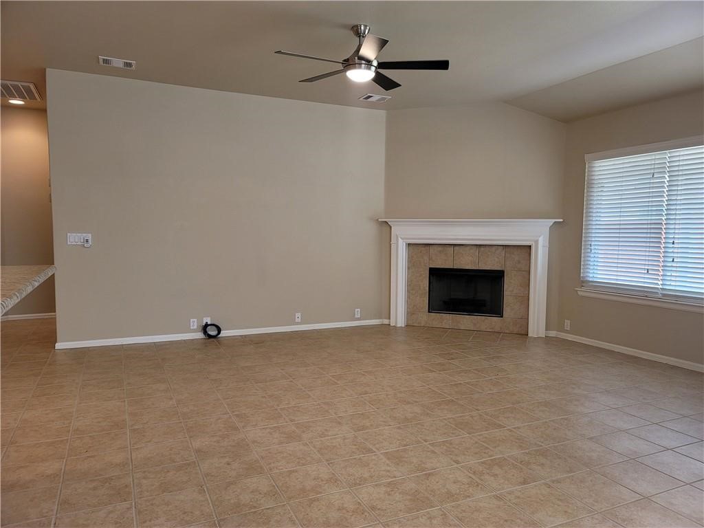 208 Hummingbird Lane Leander, TX 78641 - Photo 9 of 25 A generous living area presents a tiled fireplace and ample space for comfortable gatherings.