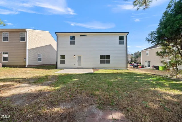 a view of a house with a backyard