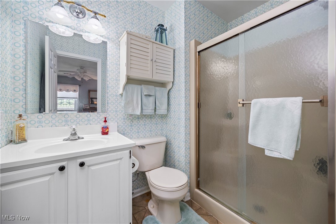 1507 Cleveland Road East, Unit 435 Huron, OH 44839 - Photo 18 of 37 Bathroom with ceiling fan, vanity, toilet, walk in shower, and tile patterned flooring