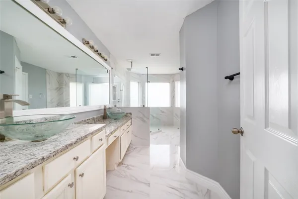 a spacious bathroom with a granite countertop sink mirror and double