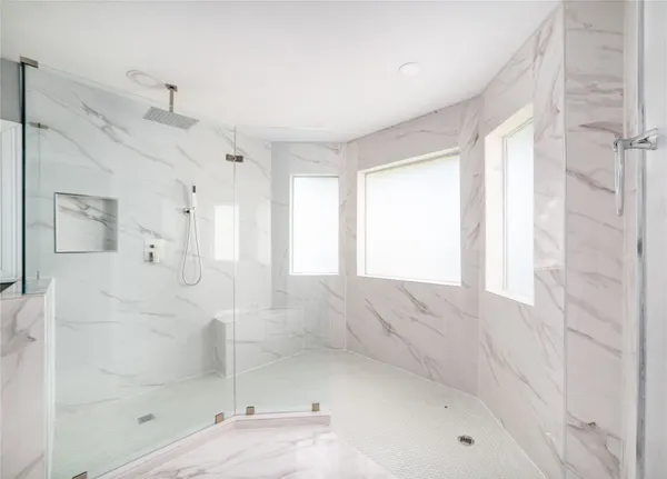a bathroom with a bathtub and shower