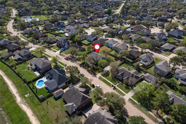 an aerial view of residential houses with outdoor space