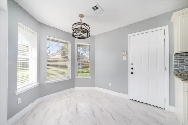 a view of a livingroom with a hardwood floor and window