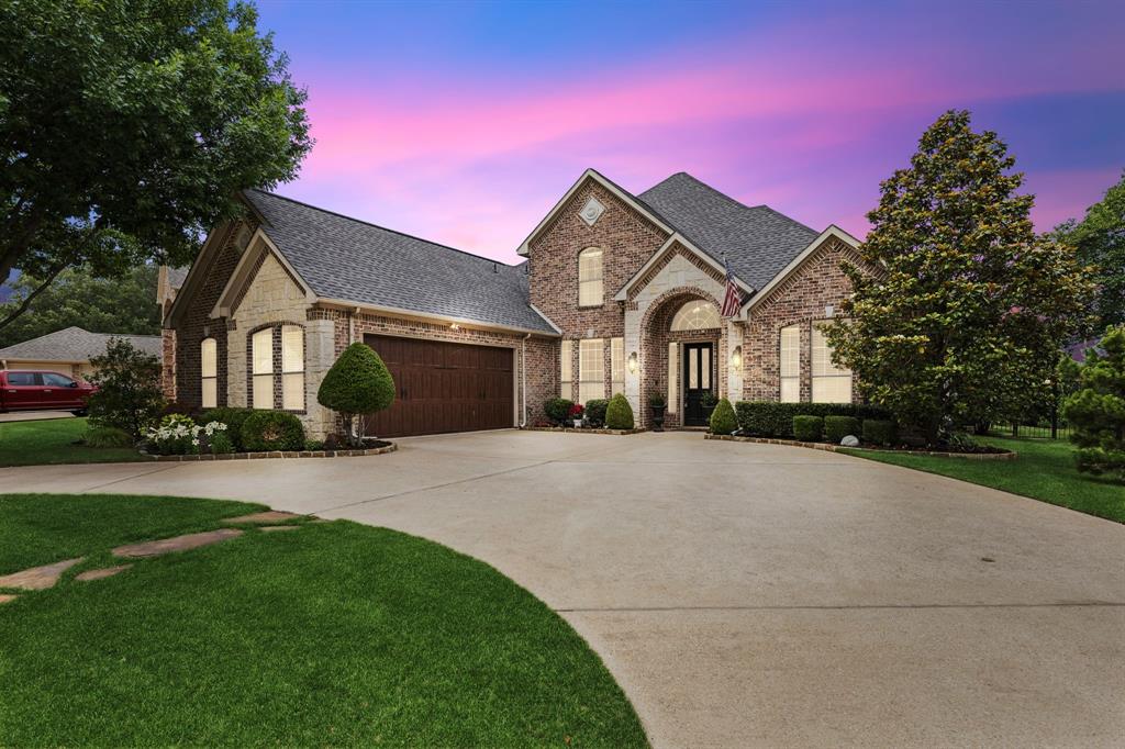 8517 Navigation Drive Rowlett, TX 75088 - Photo 1 of 39 a front view of a house with a yard and garage