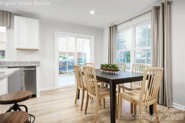 a view of a dining room with furniture and a window