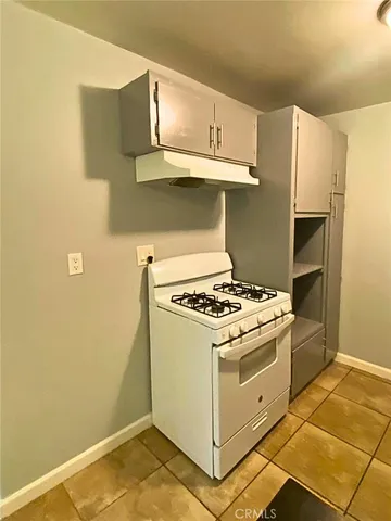 a kitchen with a stove and a refrigerator